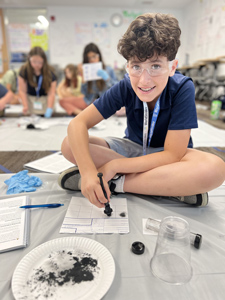 Students process a staged crime scene at NYLF Explore STEM