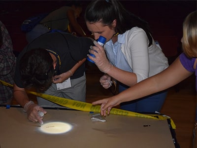Students process a staged crime scene at NYLF Explore STEM