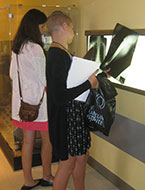 Students look at x-ray images during an NYLF Explore STEM medical simulation